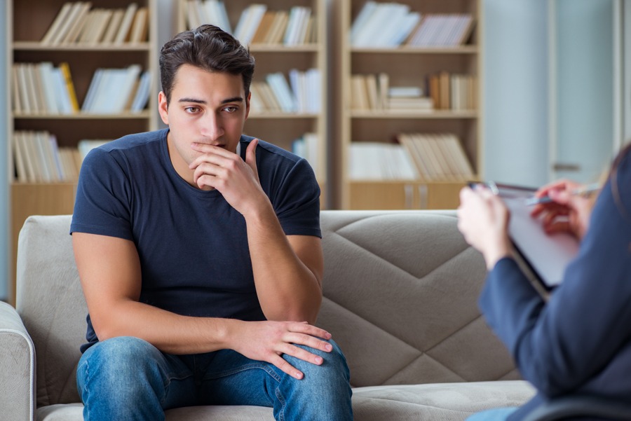 Man in counseling session exploring the distinctions between BPD vs bipolar symptoms.