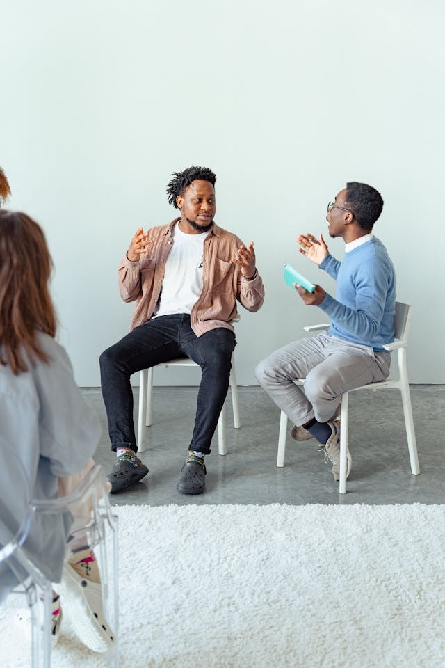 two men talking during group therapy