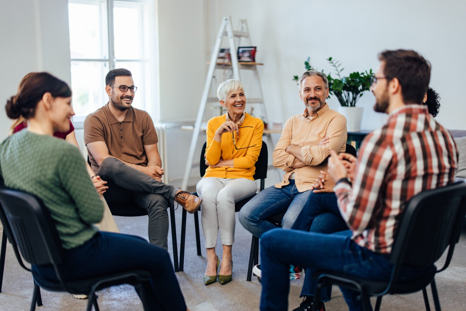 group of people with neurodivergent symptoms sitting in circle during therapy